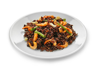 Plate with boiled rice with shrimps and vegetables on white background