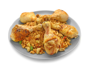 Plate with boiled rice, chicken legs and vegetables on white background
