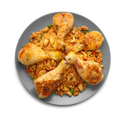 Plate with boiled rice, chicken legs and vegetables on white background