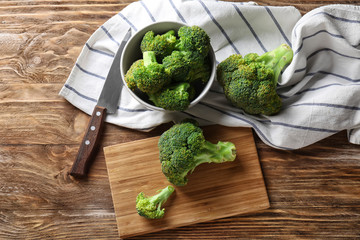 Composition with fresh green broccoli on wooden table