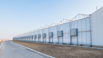 greenhouse facade with air conditioning and air ducts outside