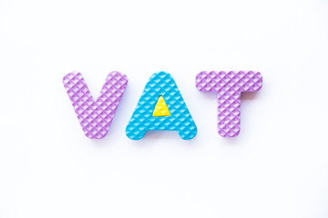 Color toy foam alphabet in word VAT (Abberviation of Value added tax) on white background