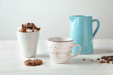 Composition with tasty cocoa and marshmallows on white table