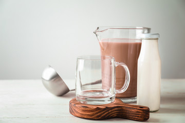Composition with tasty cocoa on white table
