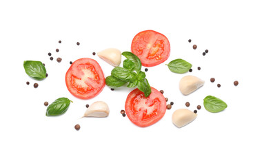 Sliced tomatoes with fresh basil and spices on white background