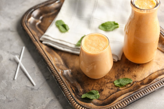 Glass And Bottle Of Tasty Melon Smoothie On Vintage Tray