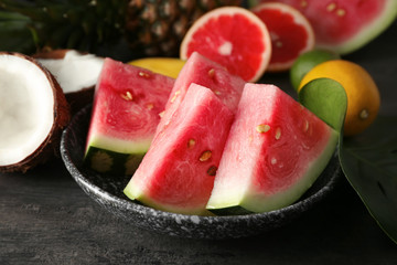 Plate with slices of ripe watermelon on table