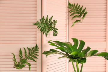 Folding screen with green tropical leaves