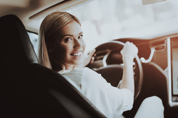 Woman In Tesla Car. Behind The Wheel Concept.