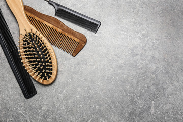 Hair brush with combs on grey background
