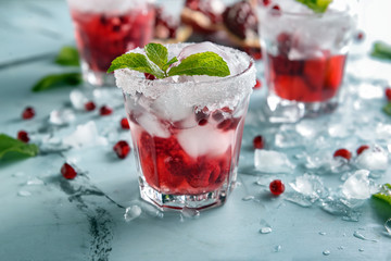 Fresh summer cocktail in glass on color table