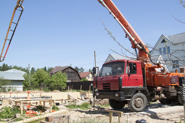 Fototapeta na wymiar concrete pump on the site counstruction of foudation slab