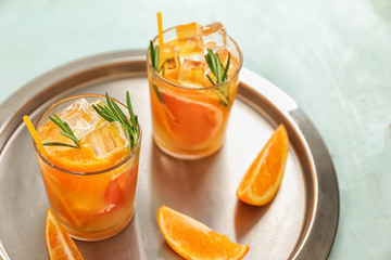 Glasses of cold tasty cocktail on tray