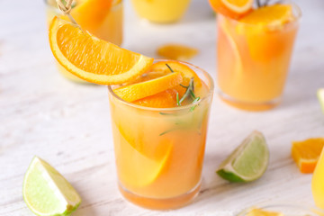 Glass of tasty cocktail on light background