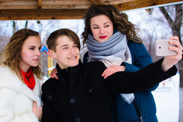 a group of friends doing selfie in a gazebo in the park
