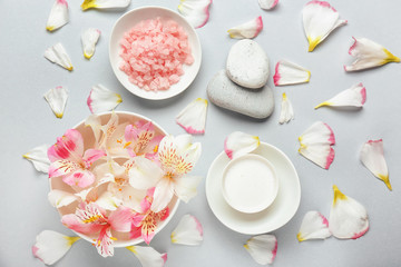 Beautiful spa composition with flower petals on light background