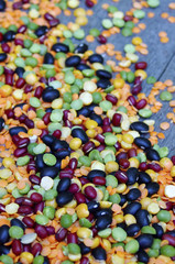 Beans of different colours  on rustic wooden background 
