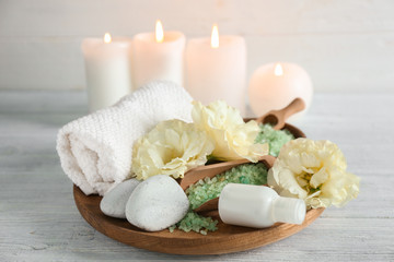 Fototapeta na wymiar Wooden tray with spa treatments on light table