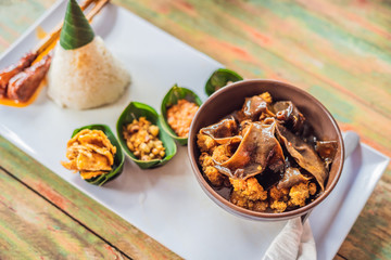 Lifestyle food. A dish consisting of rice, fried fish with wood mushrooms and different kinds of sauces