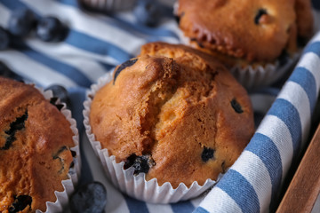 Tasty blueberry muffins on napkin, closeup