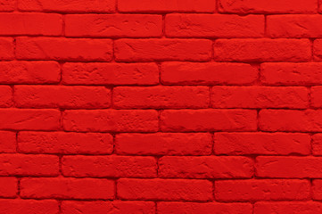 red brick wall painted at saturated scarlet colour.