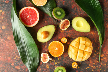 Flat lay composition with various delicious exotic fruits on color background