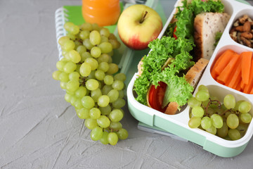 Lunch box with appetizing food on table
