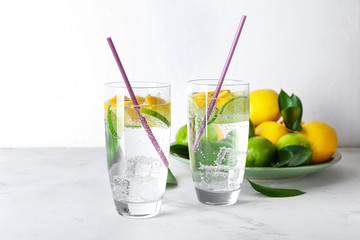 Glasses of fresh lime lemonade on light table