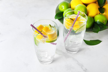 Glasses of fresh lime lemonade on light table