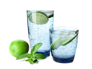 Glasses of fresh lime lemonade on white background