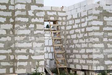 exterior of a country house under construction. Site on which the walls are built of gas concrete blocks