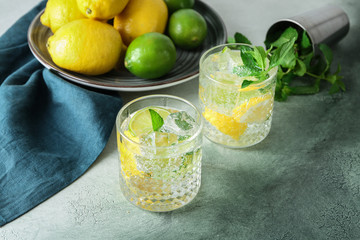 Glasses of fresh lime lemonade on grey table