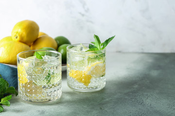 Glasses of fresh lime lemonade on grey table