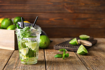Jar of fresh lime lemonade on wooden table