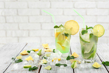 Fresh summer cocktail in glasses on light wooden table
