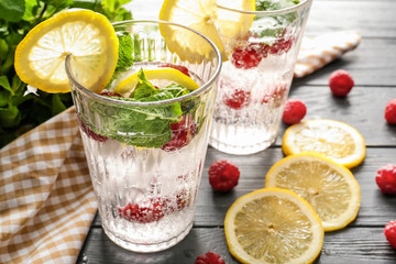 Glasses of fresh raspberry lemonade on wooden table