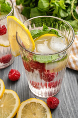 Glass of fresh raspberry lemonade on wooden table