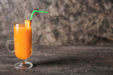 Glass of tasty melon smoothie on grey table