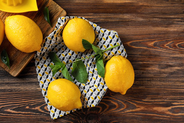 Whole ripe lemons on wooden table