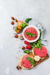 Homemade raw organic minced beef meat burger cutlet and vegetables