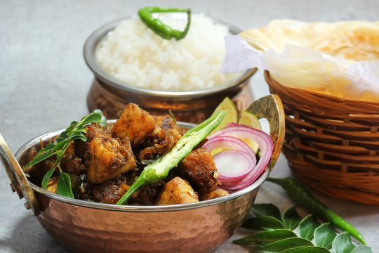 Kerala Pork Fry or Roast served with Parotta and rice, selective focus