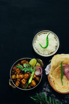 Kerala Pork Fry or Roast served with Parotta and rice on black background