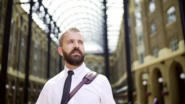 Businessman on the trian station in London, looking from side to side.