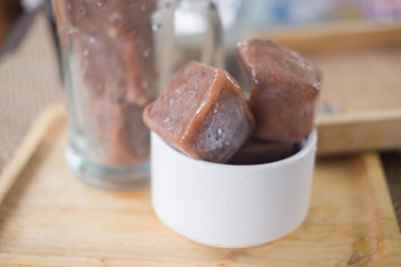 Ice cubes made with cocoa in a glass