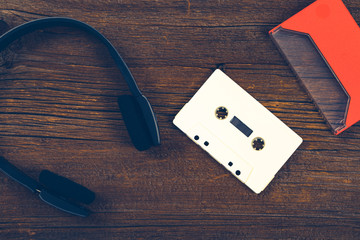 Compact Audio Cassette Tape on Wooden Background. Photo in retro style. Toned image.