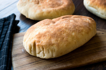Asian Gua Bao Bun Pita Bread on Wooden Surface.
