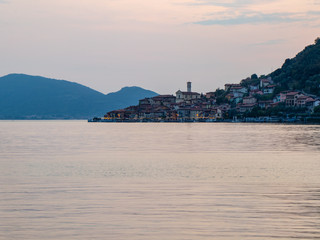 Sunset over Iseo Lake in Italian Alps, the Island and town of Monte Isola in northern Italy a...