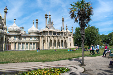 People enjoying the gardens of the Royal Pavilion in Brighton, Sussex, UK