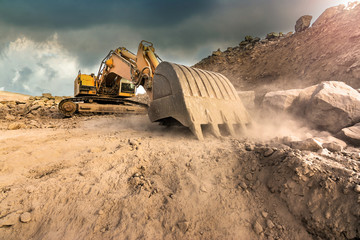 Large excavator extracting stone in a dust cloud in a desert © Enrique del Barrio