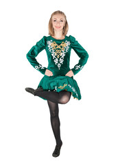 Beautiful young woman in Irish dance green dress jumping isolated